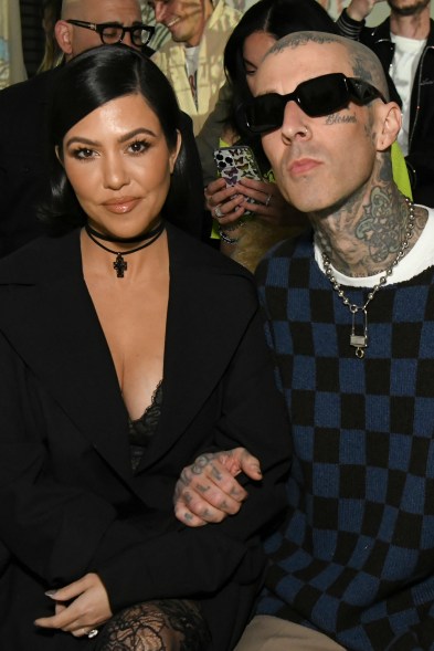 Betrothed baddies: Kourtney Kardashian and fiancé Travis Barker cut fashionable figures at an Amiri runway show.