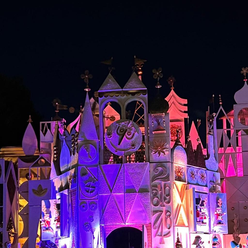 The exterior of the Sleeping Beauty Castle at Disneyland at nighttime.