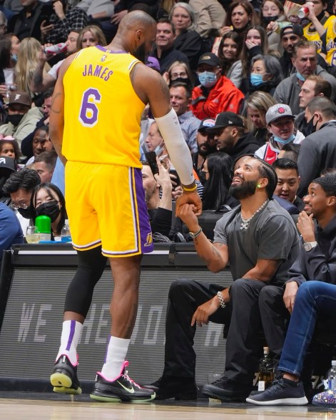 Drake at the lake: LeBron James takes time out of the game against the Toronto Raptors to greet his good pal Drake.