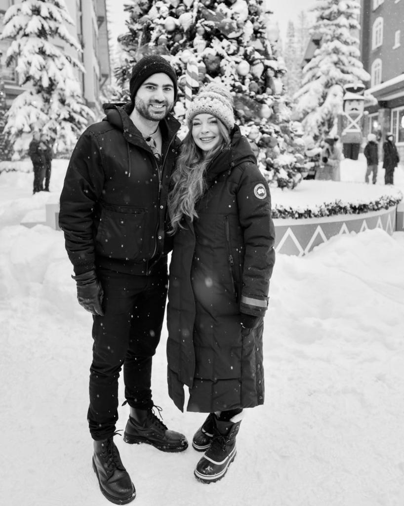 A black-and-white photo of Lindsay Lohan and Bader Shammas posing and smiling