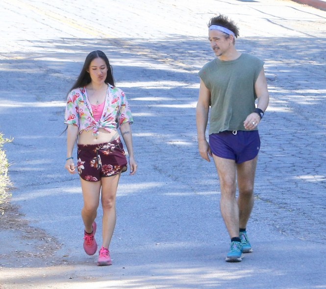 Colin Farrell, dressed like he's in the '80s, goes for a walk with a mystery woman.