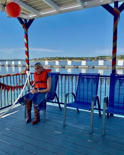 Katy Perry sitting alone on a dock