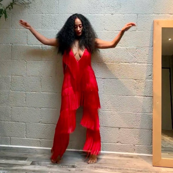 Tracee Ellis Ross wears a red fringe jumpsuit