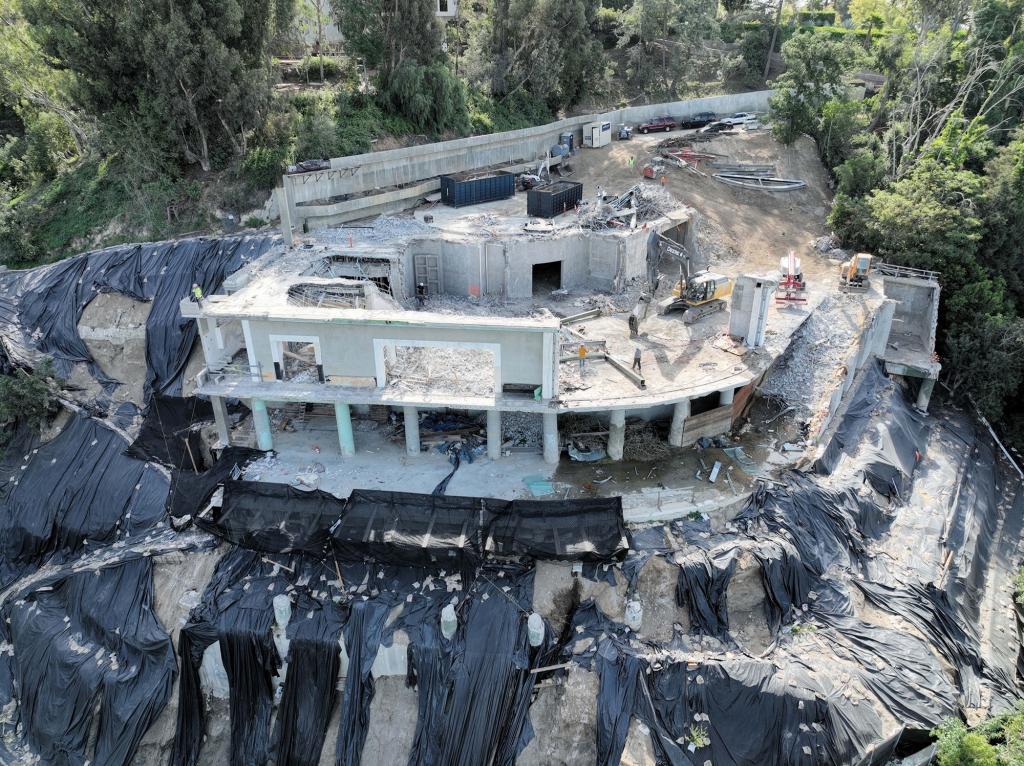 Mohamed Hadid's half-built $100 million Bel Air mega-mansion is torn down by demolition crews after judge ordered the illegally built palace to be razed - ending years-long war with neighbors.