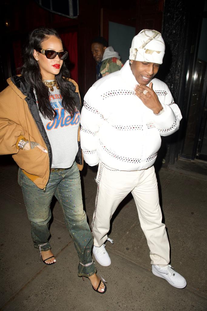 A pregnant Rihanna walking next to A$AP Rocky in New York.