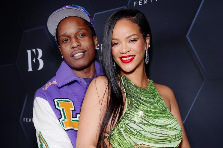 Rihanna and A$AP Rocky getting cozy on a red carpet.