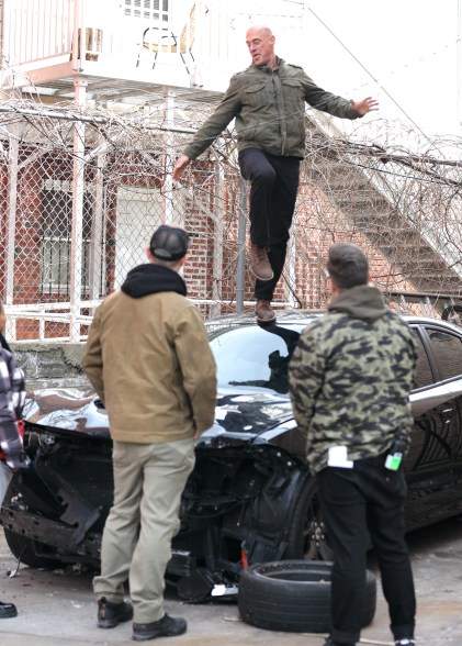 Christopher Melon stands on top of a car filming "SVU"