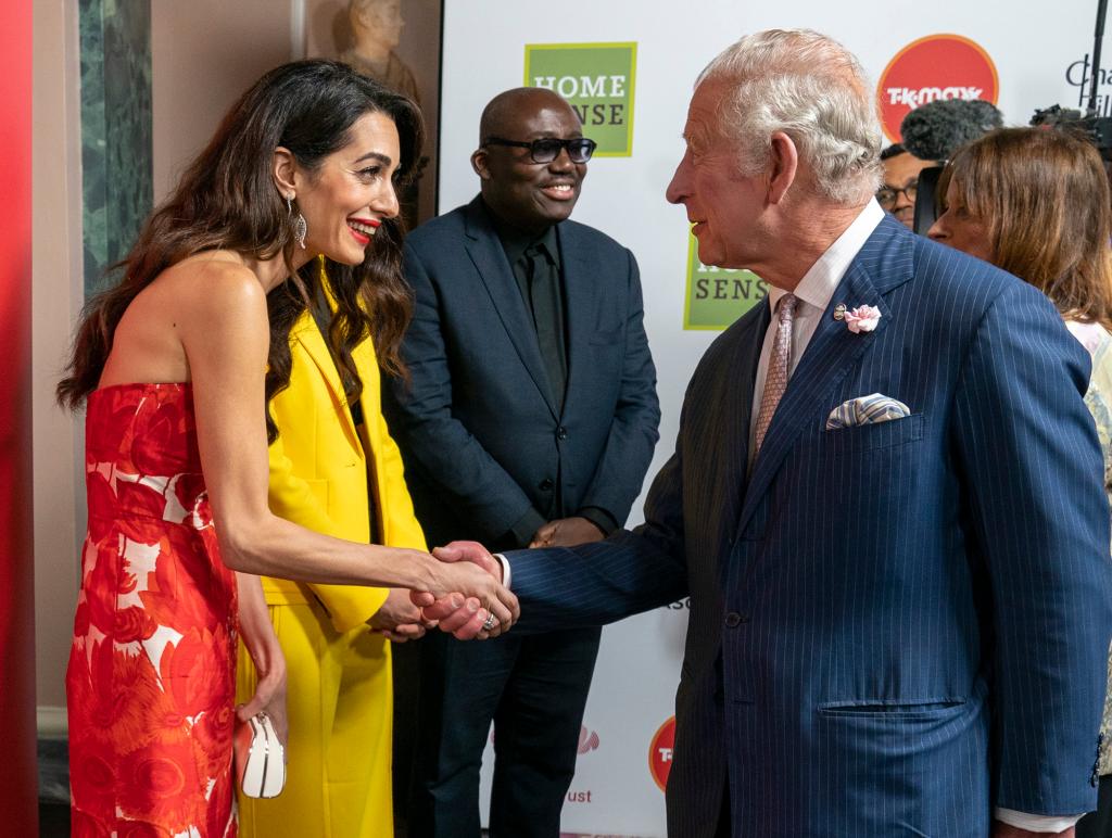 Prince Charles shaking hands with Amal Clooney