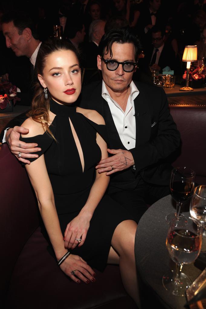 Amber Heard and Johnny Depp sitting together at an event.