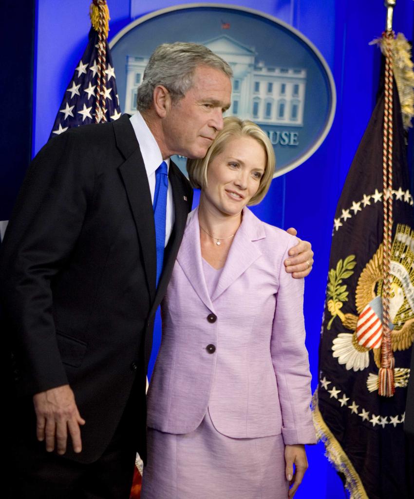 George W. Bush hugging Dana Perino in the White House briefing room.