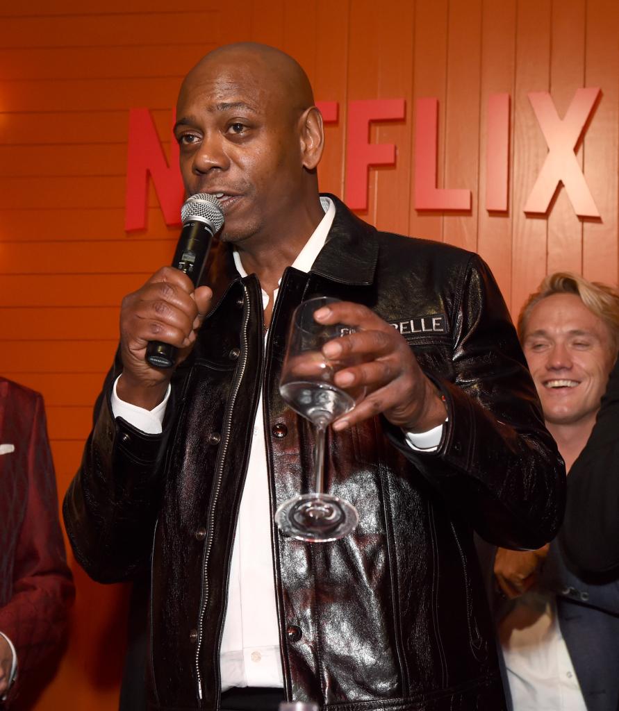 Dave Chappelle talking into a microphone.