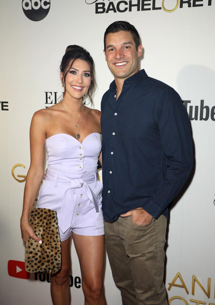 Becca Kufrin and Garrett Yrigoyen on a red carpet.