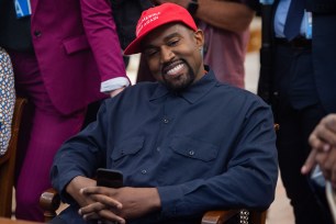 Kanye West wearing a "Make America Great Again" hat.