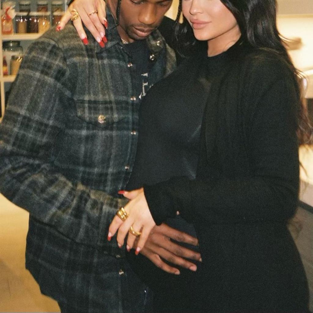 Travis Scott touching pregnant Kylie Jenner's baby bump.