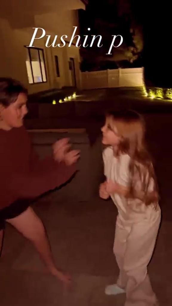 Mason Disick pushing Penelope Disick.