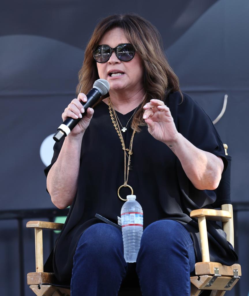 Valerie Bertinelli talking into a microphone at a speaking engagement