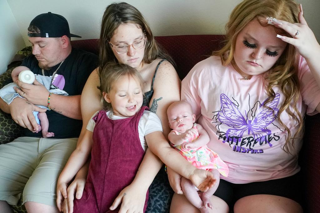 Alana Thompson holding her sister Lauryn Shannon's baby next to her family.