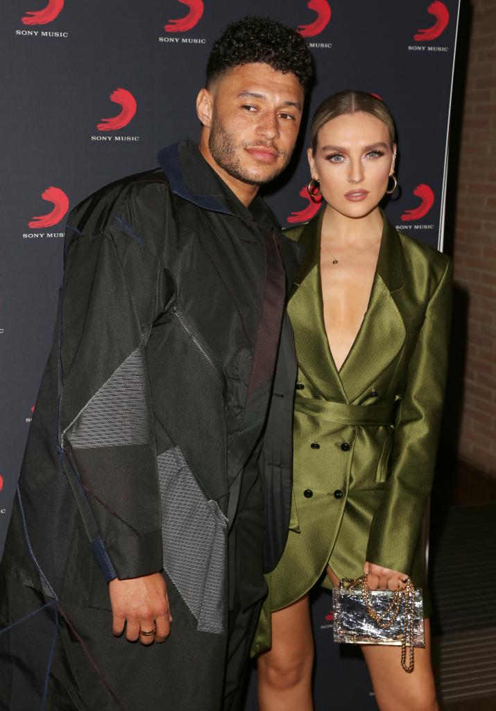 Alex Oxlade-Chamberlain and Perrie Edwards posing on a red carpet together