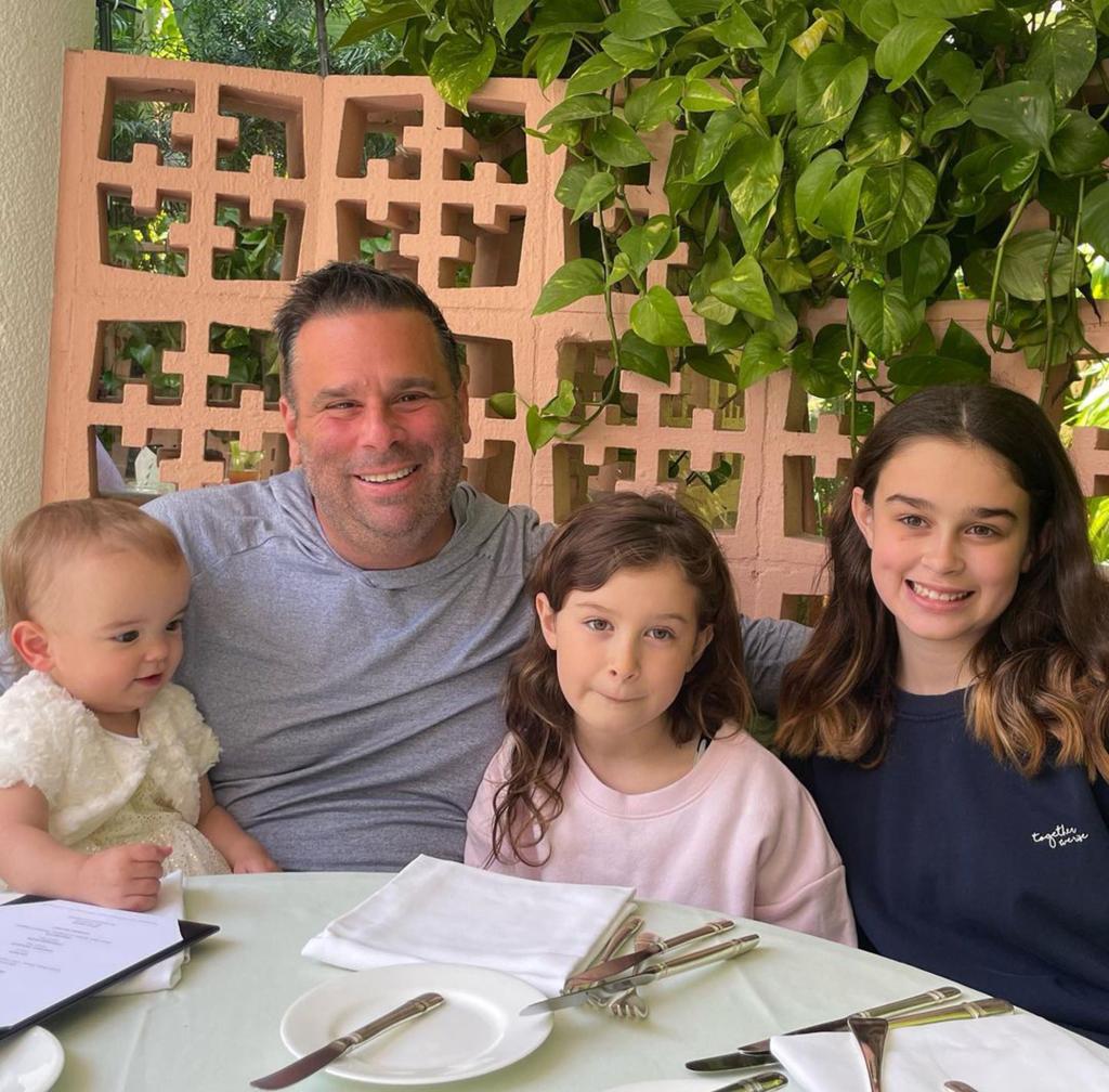 Randall Emmett posing for a photo with his three daughters.