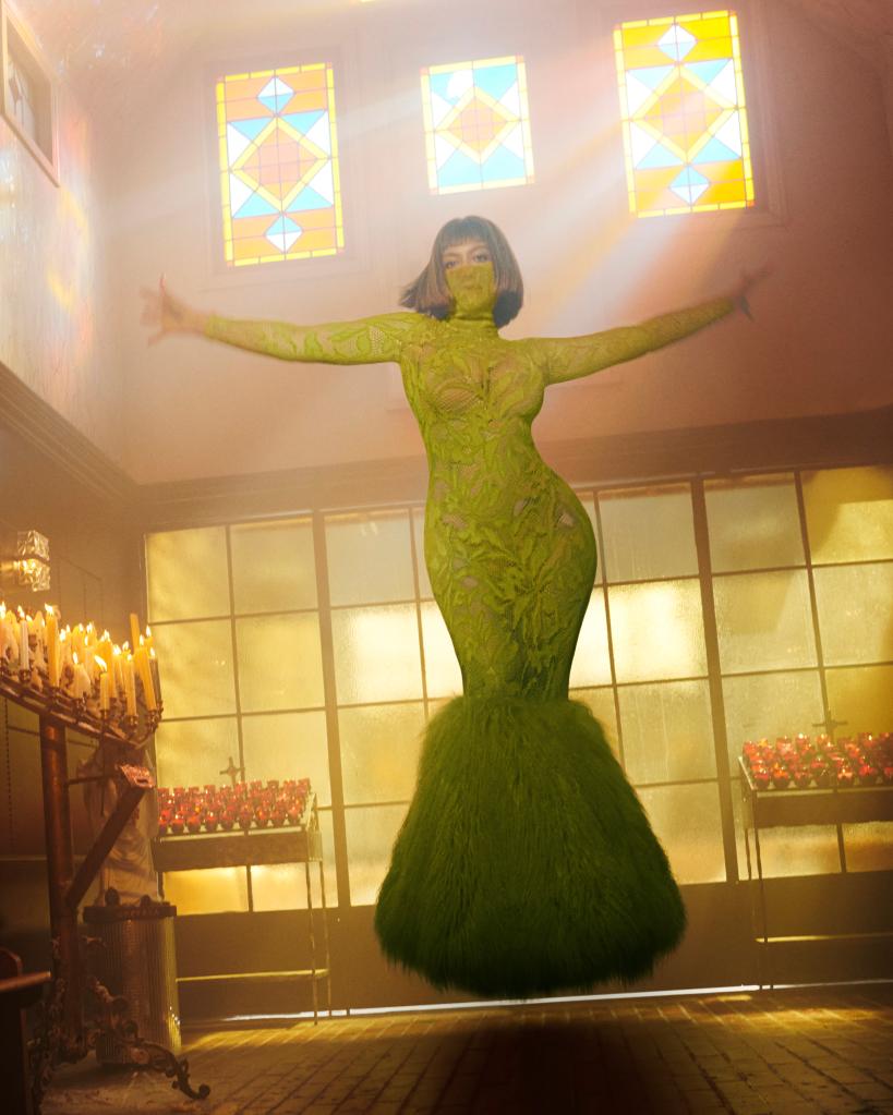 Beyoncé posing in a church in a green dress with a matching face mask.