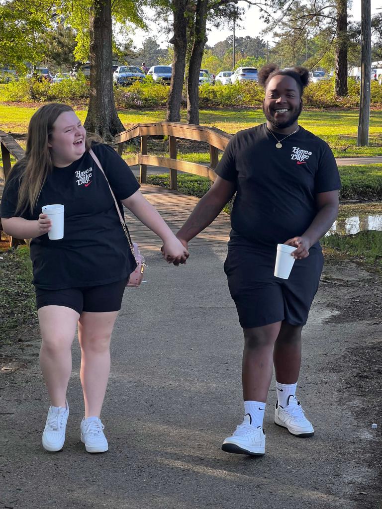 Alana Thompson and Dralin Carswell holding hands.