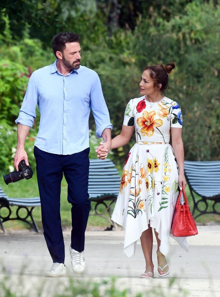 Ben Affleck and Jennifer Lopez holding hands.