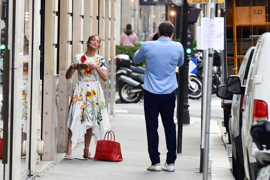 Ben Affleck taking photos of Jennifer Lopez.