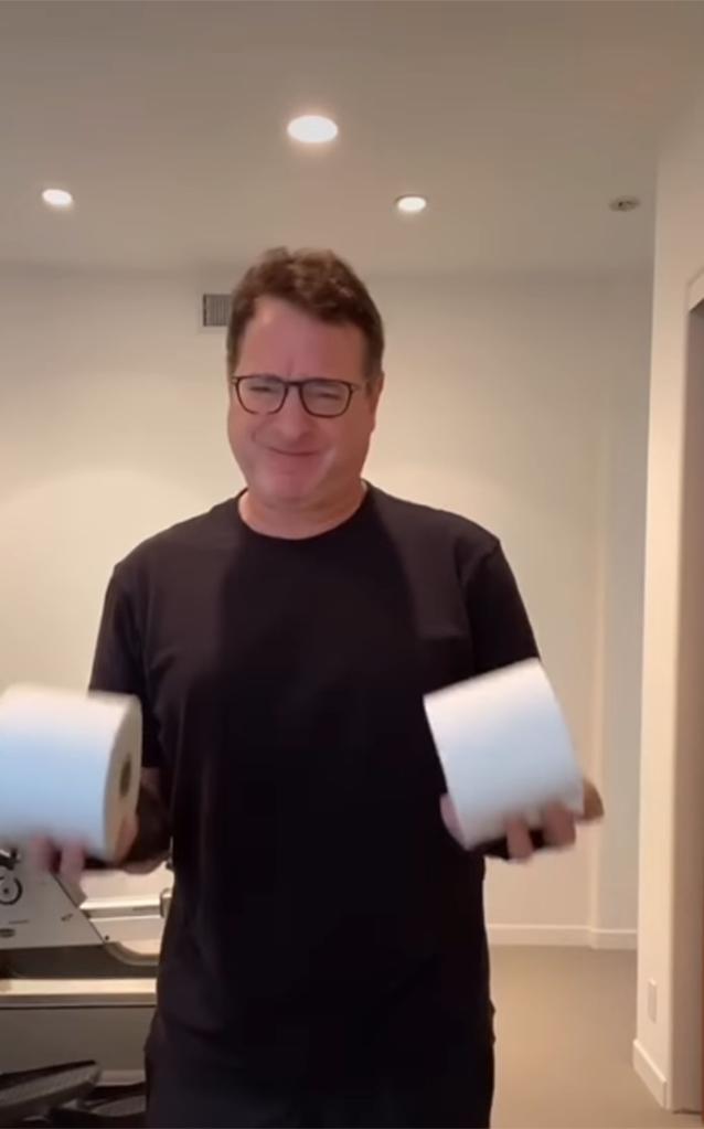Bob Saget lifting two rolls of toilet paper instead of weights.