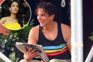 bradley cooper with a newspaper with an inset of huma abedin