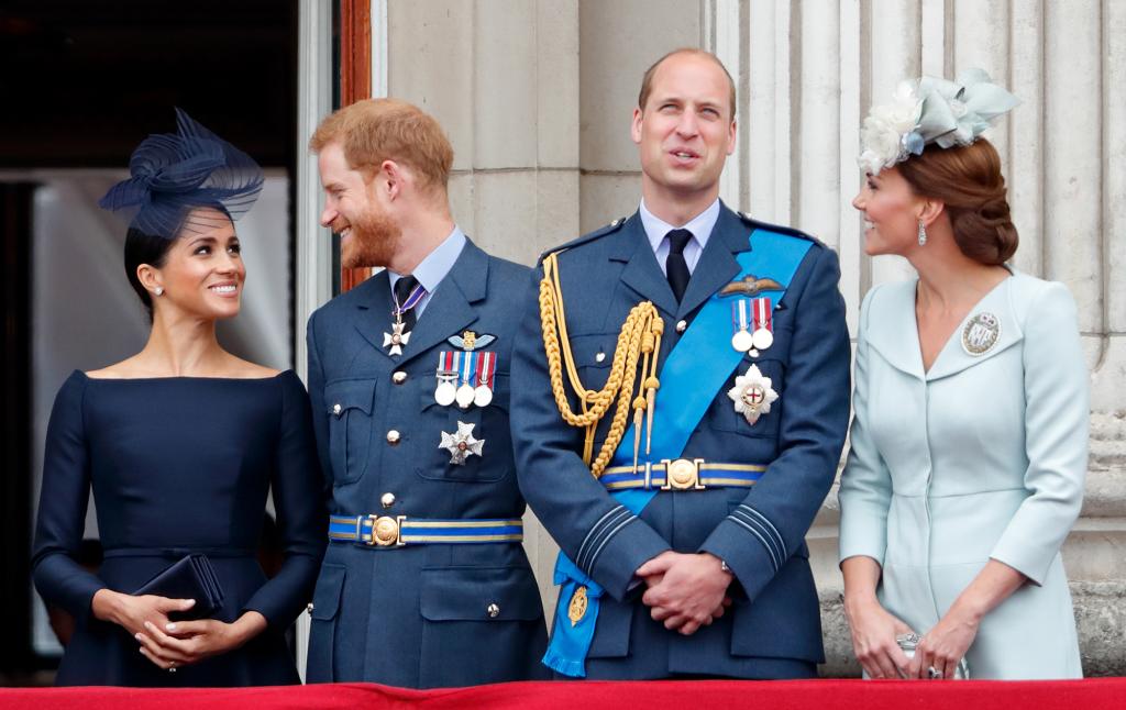 Meghan Markle, Prince Harry, Prince William and Kate Middleton standing on the balcony of Buckingham Palace.