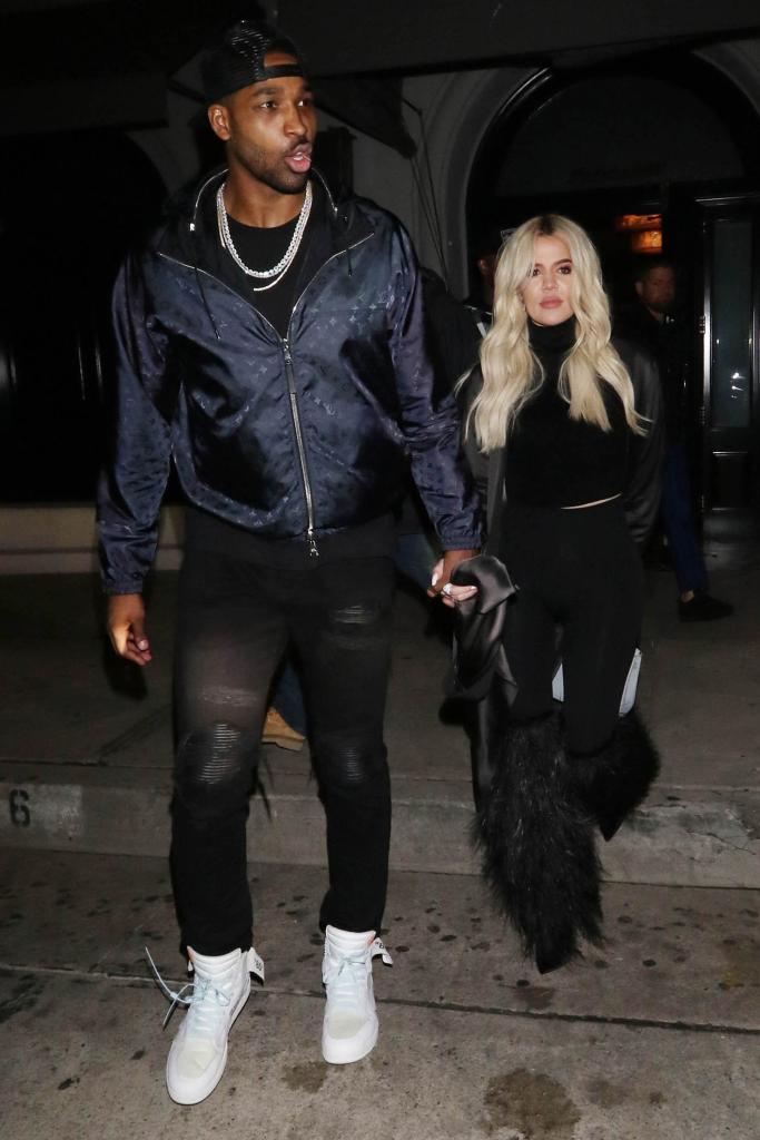 Tristan Thompson and Khloé Kardashian holding hands.