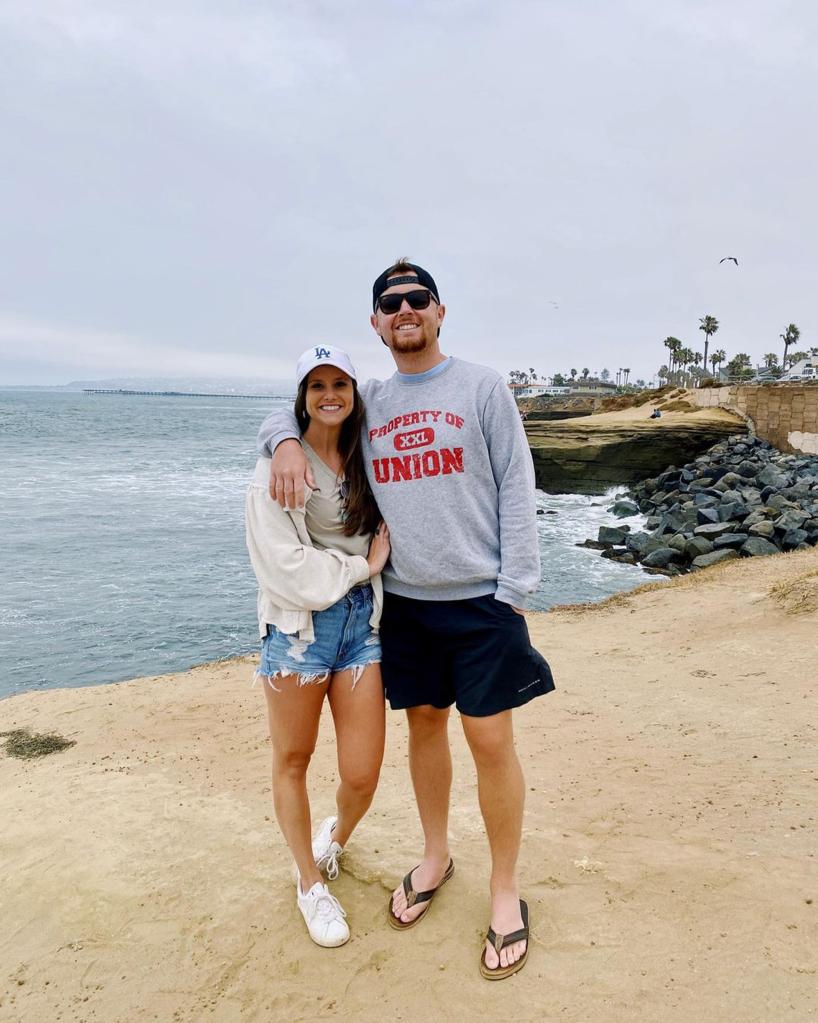 Scotty McCreery and Gabi Dugal on a beach.