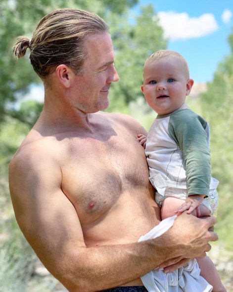 shirtless james van der beek holds his baby