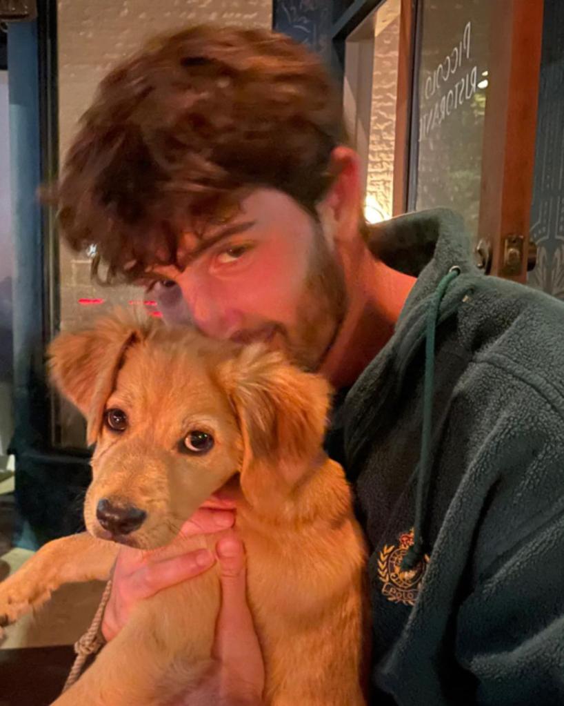 Austin Kevitch holding a puppy.