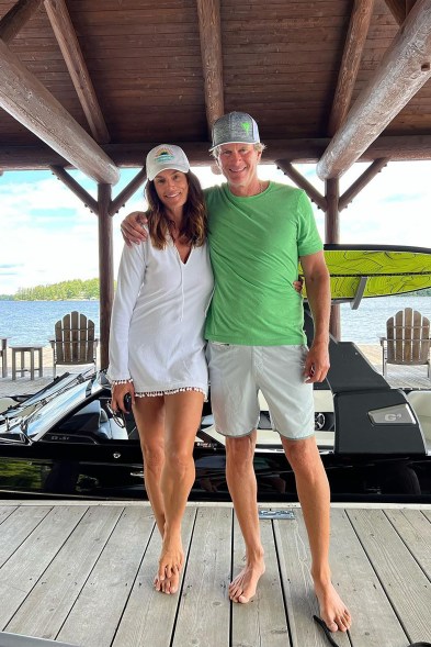 LAKESIDE LOVERS: Cindy Crawford and hubby Rande Gerber play to the suburban crowd and strike a cute pose on a dock.