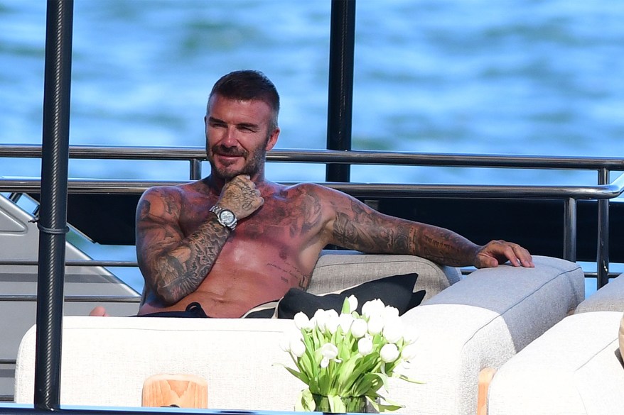 TATTED AND TAN: David Beckham sure knows how to take advantage of a day off by spending time on his yacht in Miami.