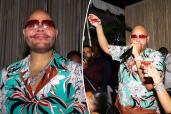 Split image of Fat Joe smiling on the left and toasting a drink on the right.