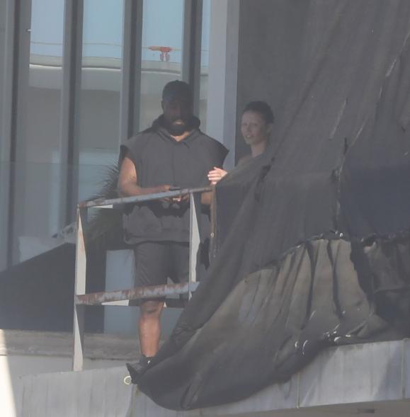 Kanye West and a mystery woman at his Malibu home.