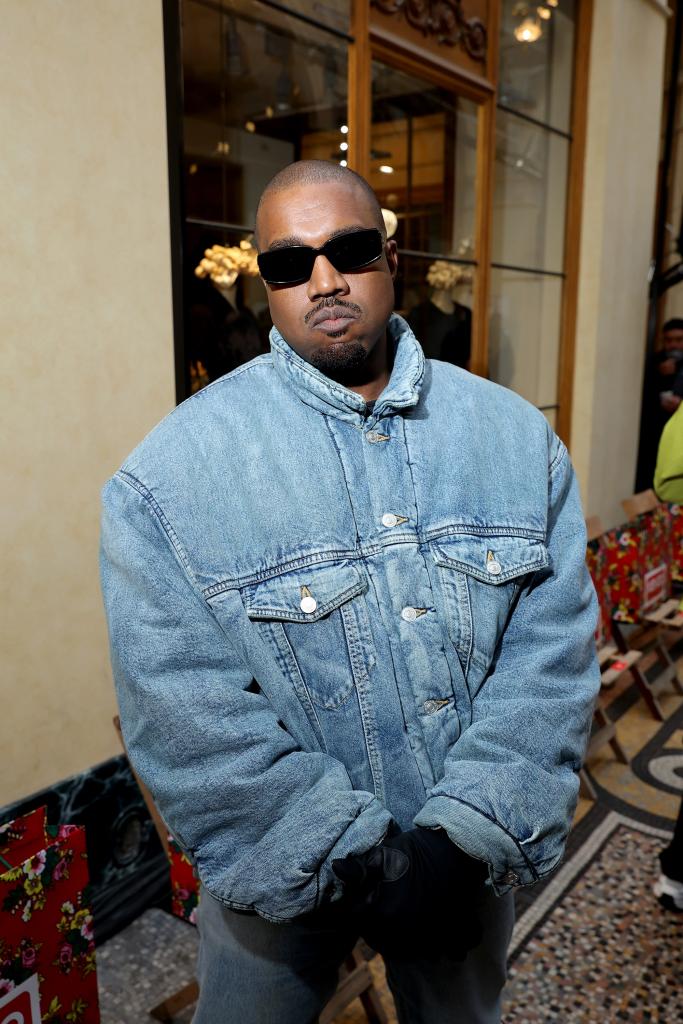 Kanye West wearing a jean jacket and sunglasses at the Kenzo Fall/Winter 2022/2023 show