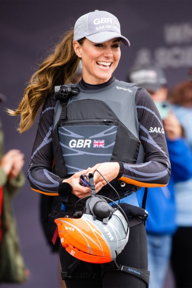 COME SAIL AWAY: Kate Middleton can’t hide her high pony or brilliant smile under a helmet during a visit with the Great Britain Sail Grand Prix team.