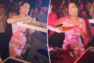 katy perry holding slices of pizza at a club
