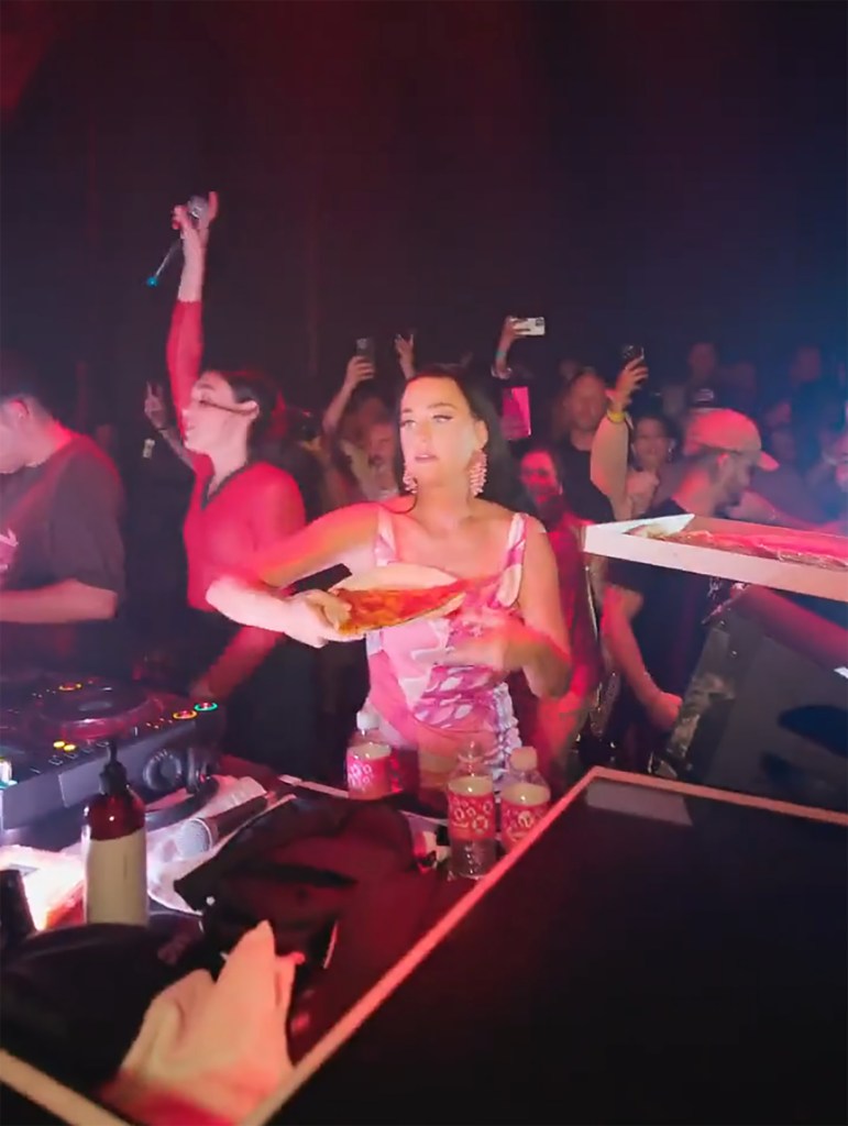 Katy Perry throwing pizza slices into a crowd at a Las Vegas nightclub.