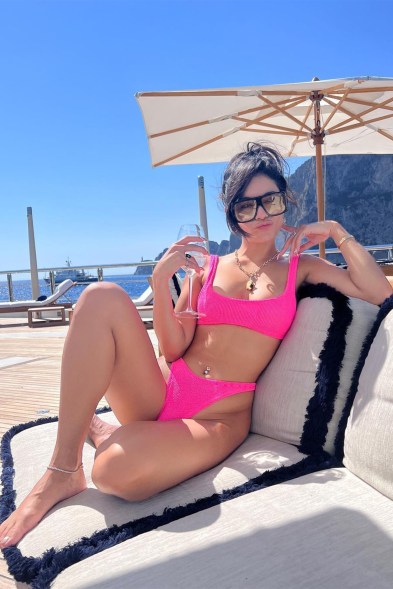 POUTY IN PINK: With a glass in her hand and sunshine on her face, Vanessa Hudgens enjoys the luxe life aboard a yacht.