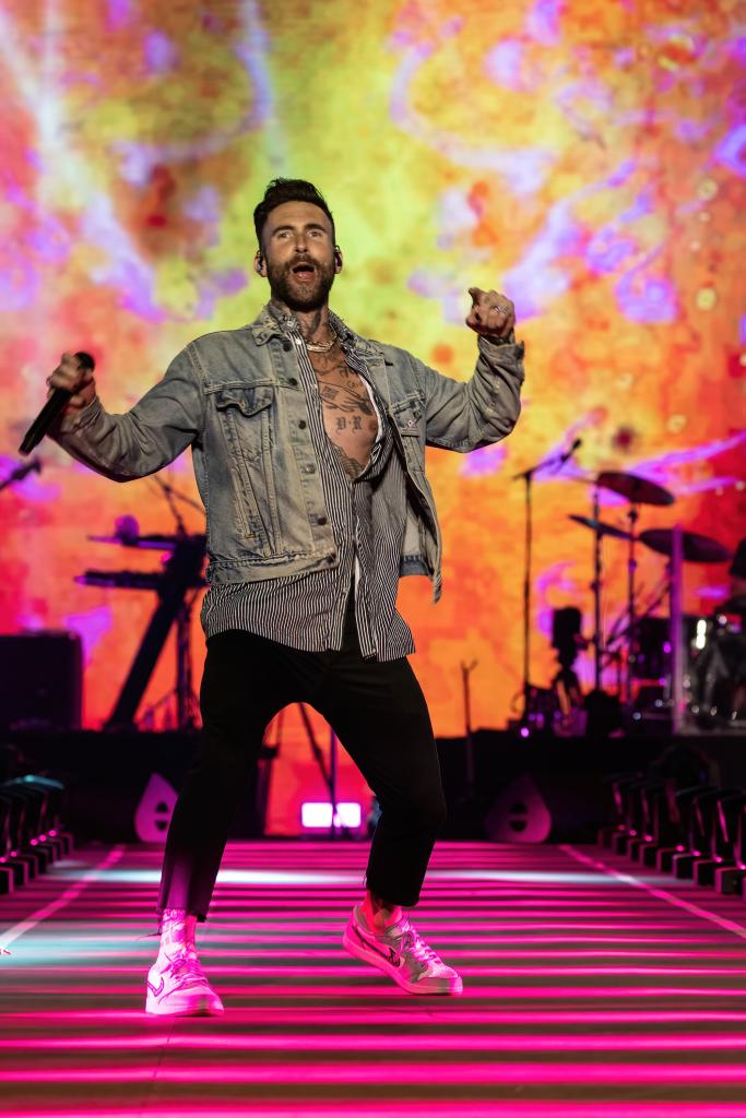 Adam Levine performing on stage.