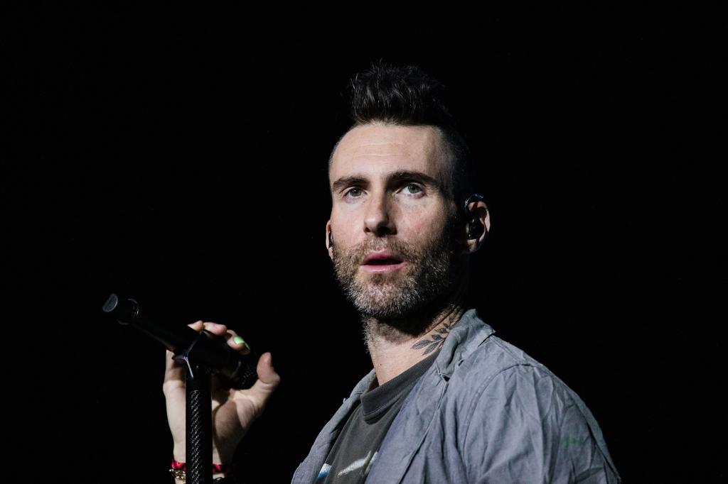 Adam Levine performing on stage.