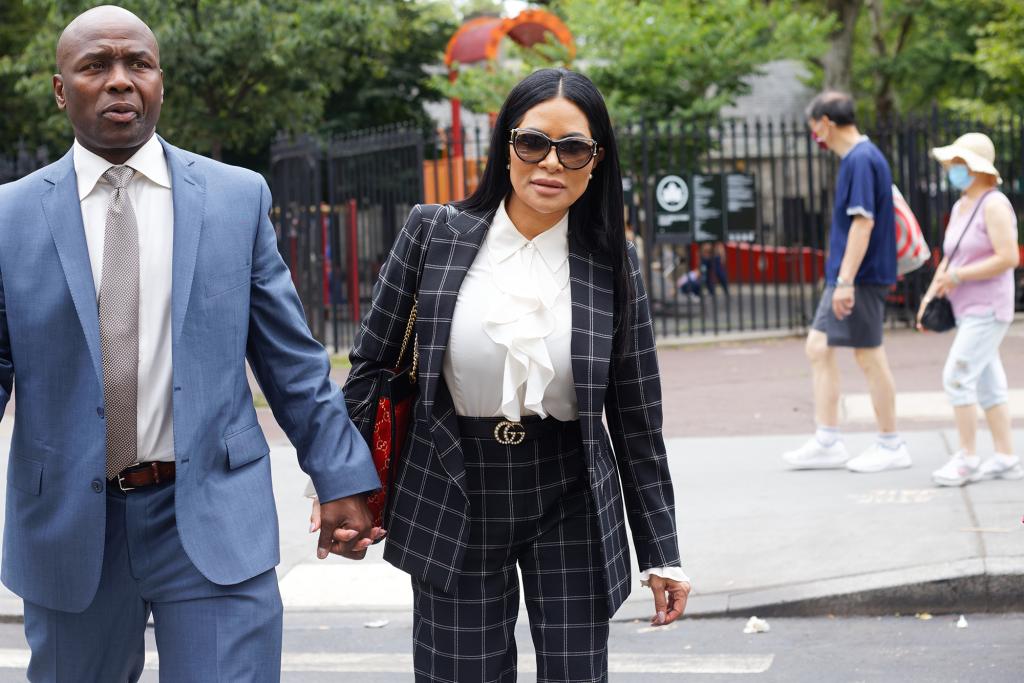 Sharrieff Shah Sr. and Jen Shah holding hands outside court.