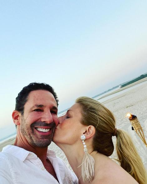 jill martin kissing erik brooks on the cheek on the beach