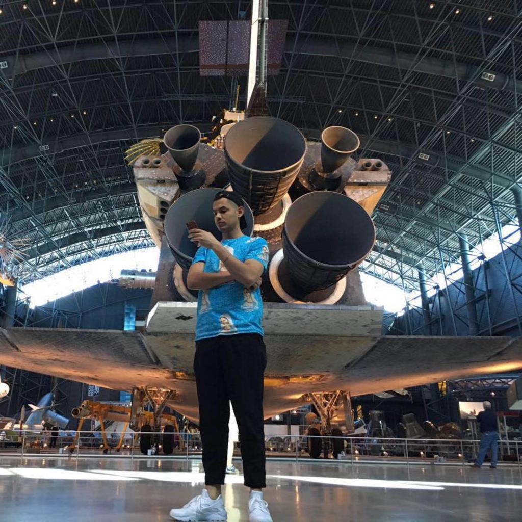 Dawit Eklund standing in front of an air force jet.