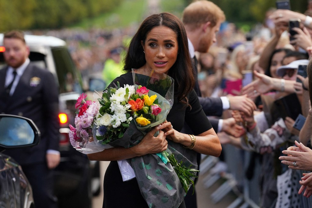 Meghan Markle holding flowers.