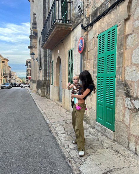 Emily Ratajkowski carrying her son